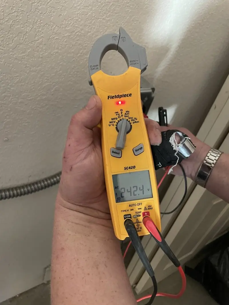 Voltage testing with clamp meter during Outlet Installation in Wilna